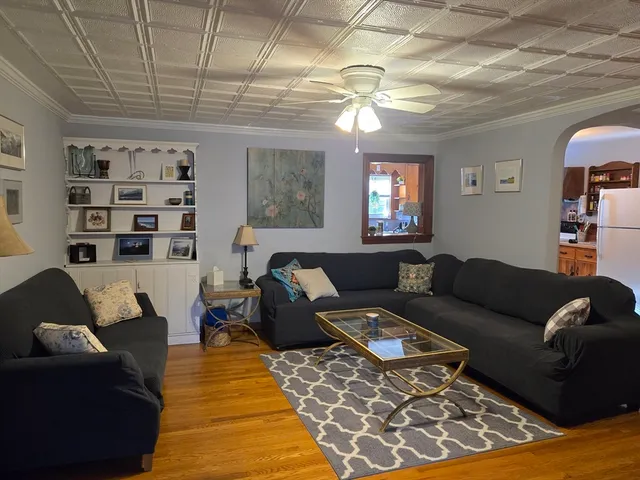 a living room with furniture a rug and a chandelier