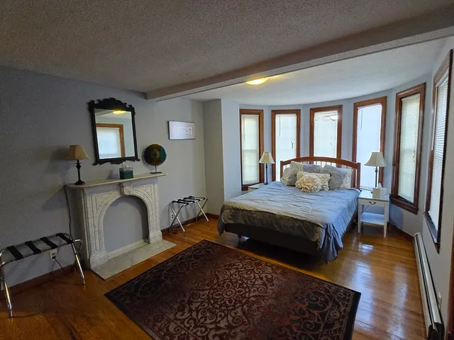 a living room with a bed furniture and a window
