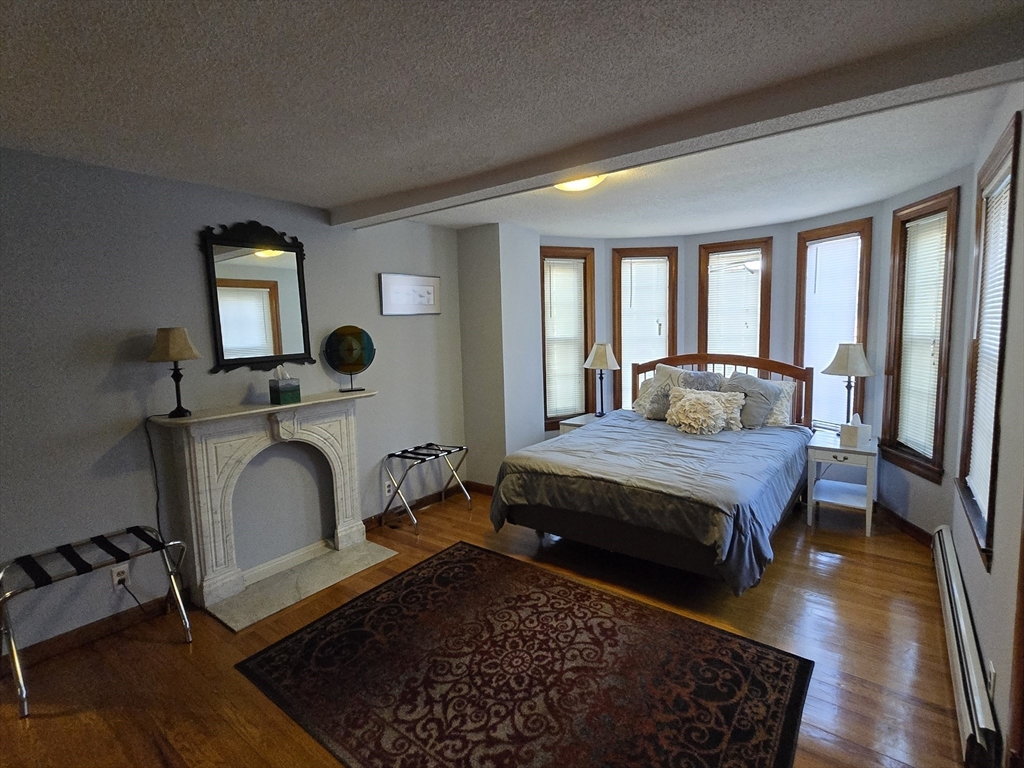 14 Parsons Street, Unit 2 Northampton, MA 01060 - Photo 10 of 28 a living room with a bed furniture and a window