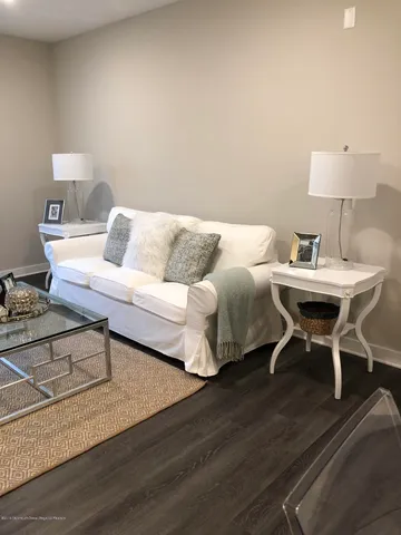 a living room with furniture a table and a lamp