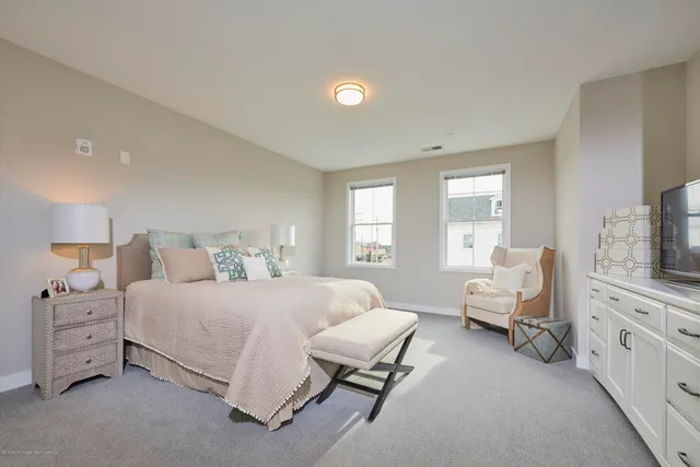 a bedroom with a bed and a couch