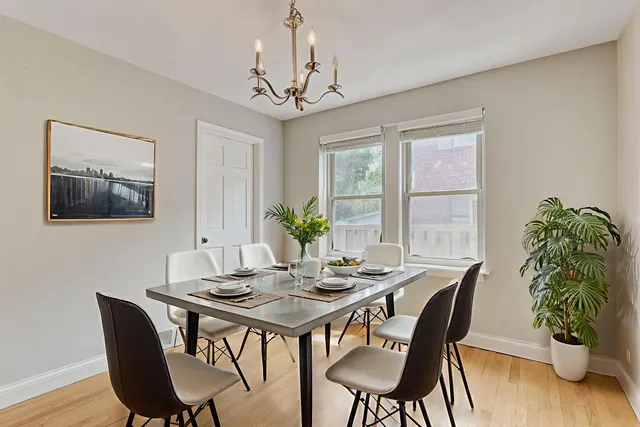 a view of a dining room with furniture window and wooden floor