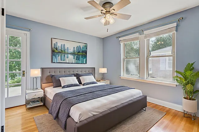a view of an empty room with wooden floor and window