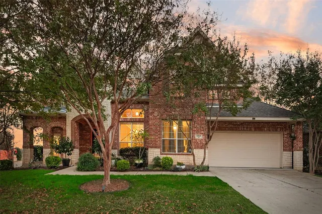 a view of a house with a tree and a yard