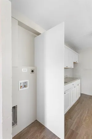 a kitchen with granite countertop white cabinets and sink
