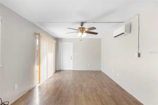 wooden floor in an empty room with a window