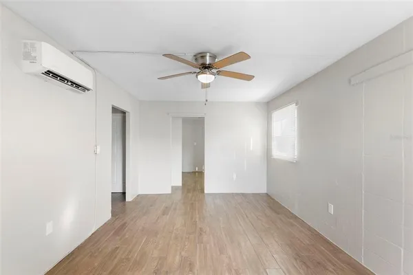 wooden floor in an empty room with a window