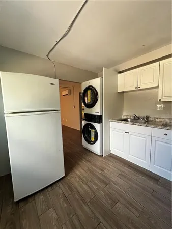a kitchen with a refrigerator and a stove