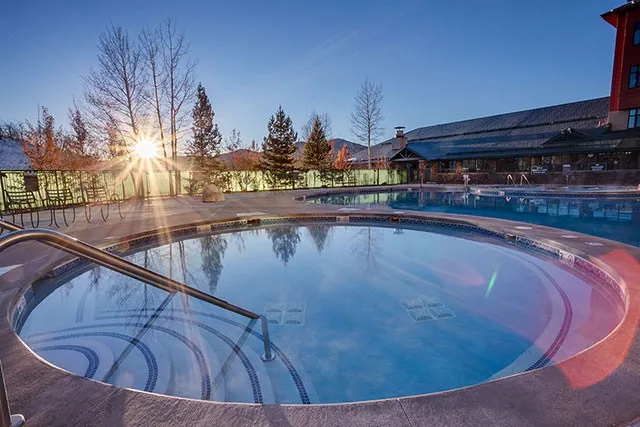 a view of a swimming pool with outdoor seating