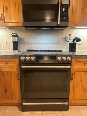 a stove top oven sitting inside of a kitchen