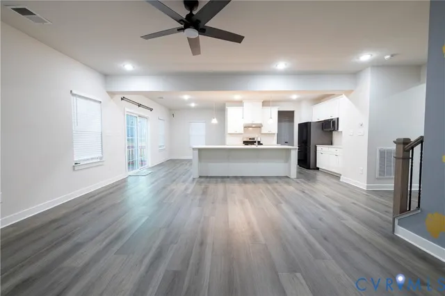 a view of a kitchen with a sink and a refrigerator