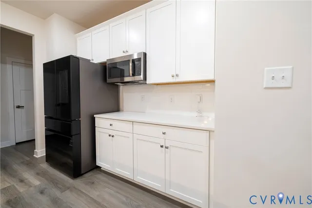 a kitchen with stainless steel appliances granite countertop a sink a stove and a refrigerator