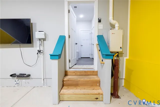 a view of a room with furniture and a flat screen tv