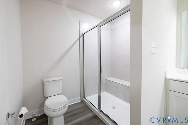 a bathroom with a double vanity sink a large mirror a bathtub and next to a window