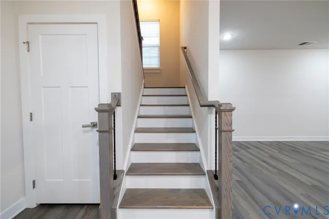 a view of entryway with wooden floor and stairs