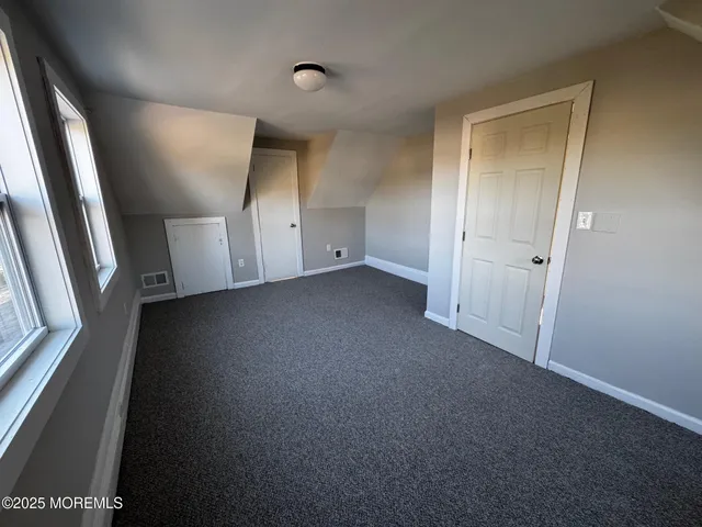 a bathroom with a double vanity sink mirror and toilet