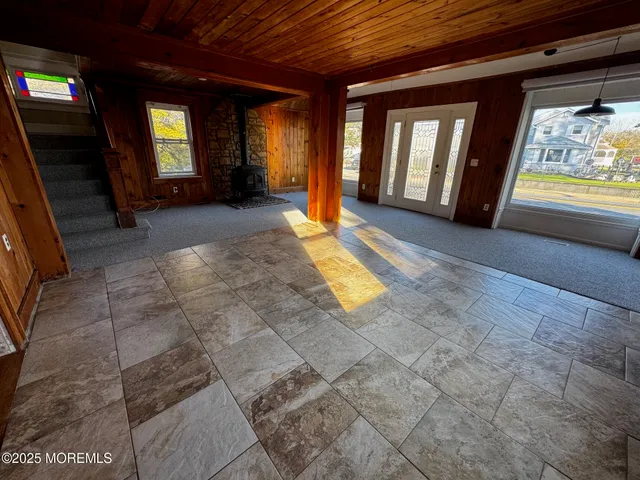 a view of a hallway with furniture and a windows