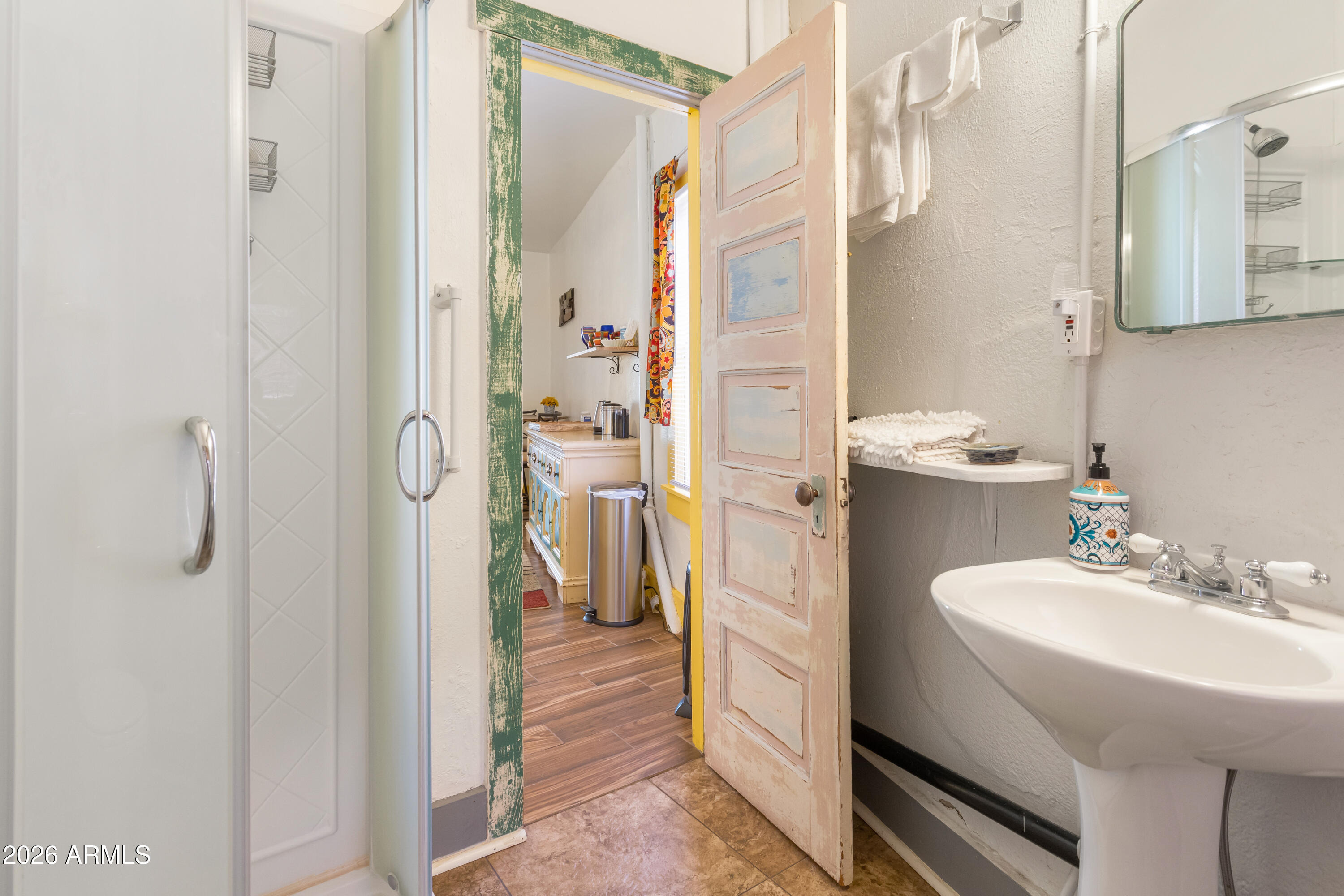 41 Main Street Bisbee, AZ 85603 - Photo 24 of 33 a bathroom with a sink a mirror and a shower
