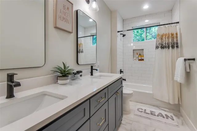 a bathroom with a double vanity sink mirror and shower