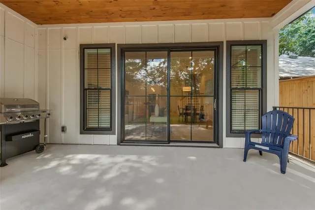 a view of a livingroom with furniture and floor to ceiling window