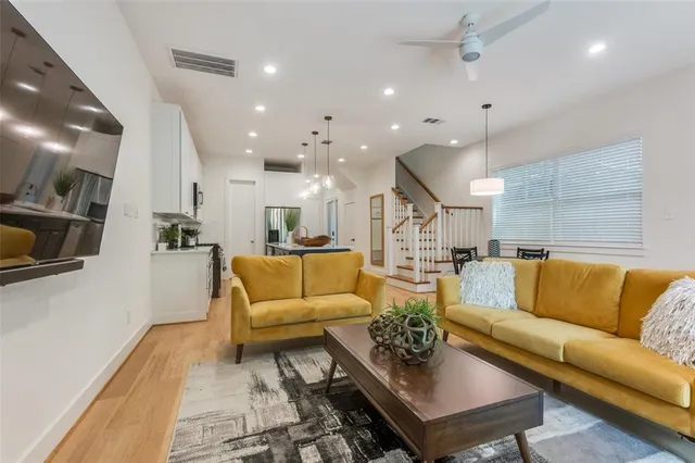 a view of a living room kitchen and a wooden floor
