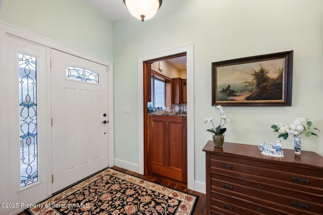 a room with painting and a potted plant