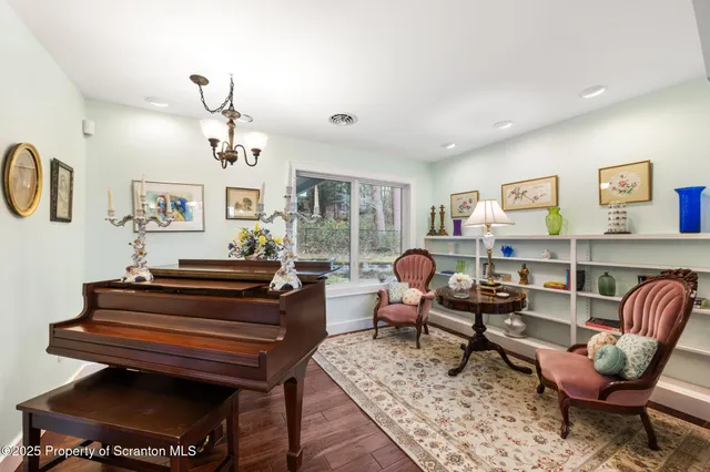 a living room with furniture a rug and a window