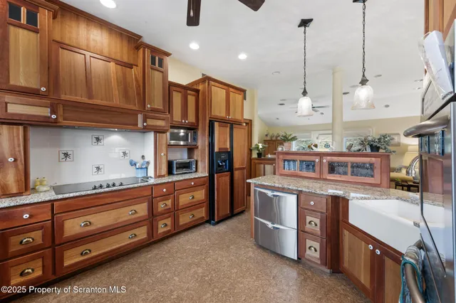 a kitchen with stainless steel appliances granite countertop a stove a sink and a refrigerator