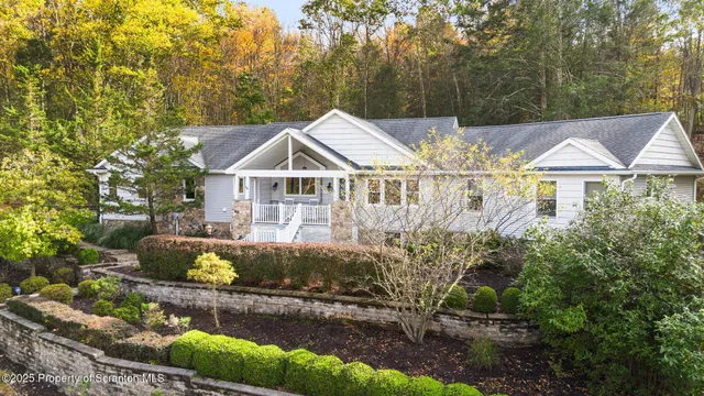 a view of a house with a yard and sitting area