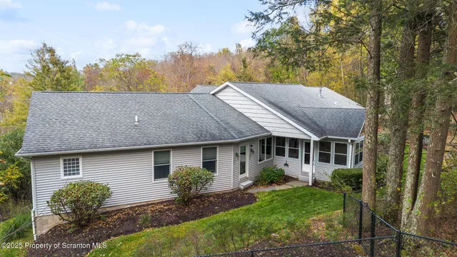 a aerial view of a house with a yard and potted plants