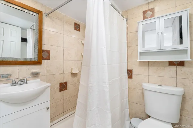 a white toilet sitting next to a bathroom sink