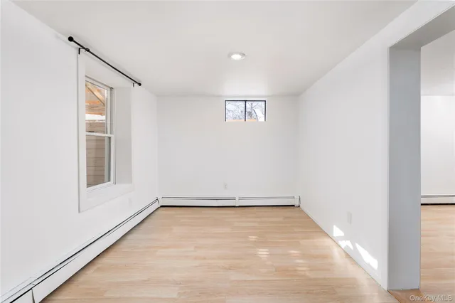 a view of room with window and hardwood floor