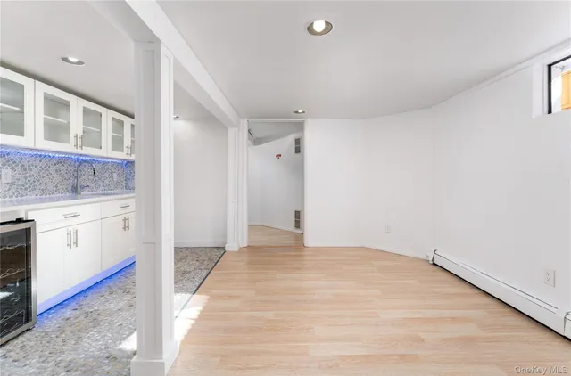 a view of a kitchen with white cabinets