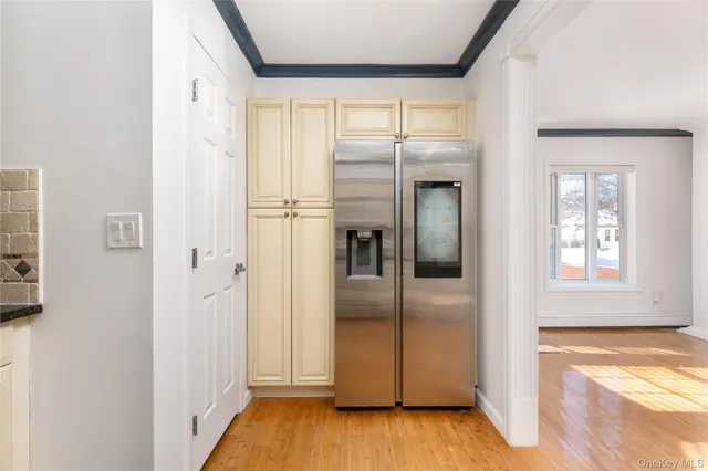 a view of a refrigerator in kitchen and wooden floor