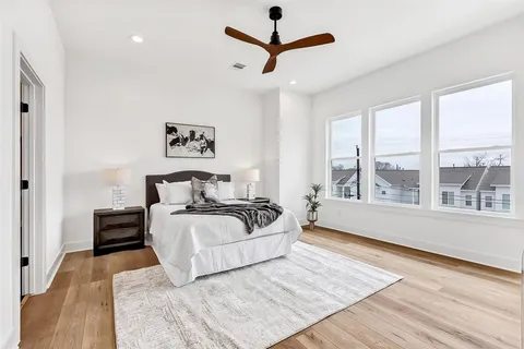 a spacious bedroom with a large bed and a large window