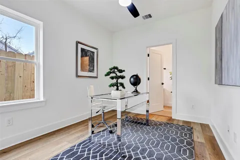 a view of workspace filled with furniture and window