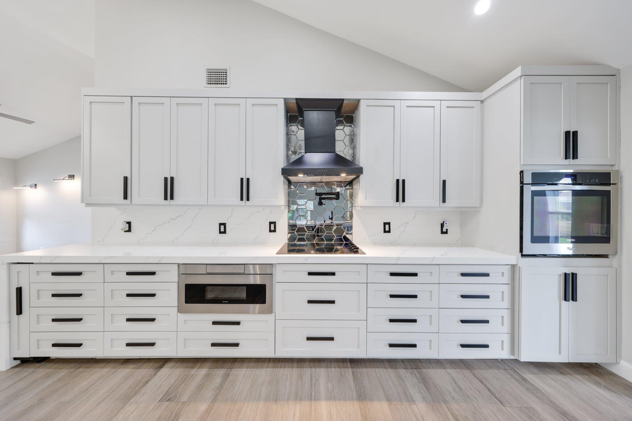 6940 Northwest 4th Avenue Boca Raton, FL 33487 - Photo 5 of 37 New stove top, dishwasher, and hood vent