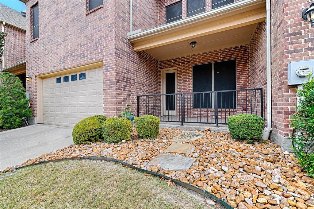 8329 Moore Street Frisco, TX 75034 - Photo 14 of 30 Doorway to property with an attached garage, brick siding, and driveway