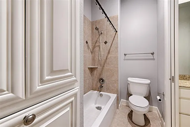 a white toilet sitting next to a bathroom sink
