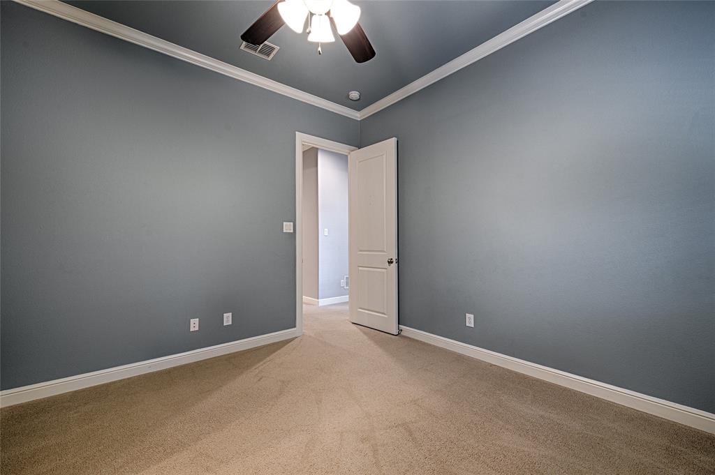 8329 Moore Street Frisco, TX 75034 - Photo 18 of 30 Spare room featuring crown molding, light carpet, and a ceiling fan