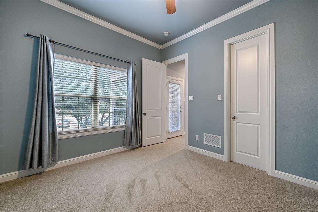 8329 Moore Street Frisco, TX 75034 - Photo 22 of 30 Unfurnished bedroom featuring light colored carpet, crown molding, and ceiling fan