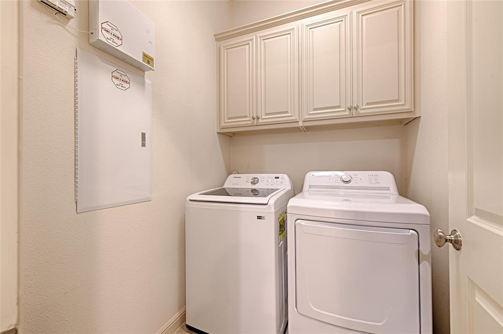 8329 Moore Street Frisco, TX 75034 - Photo 23 of 30 Laundry room featuring washer and dryer and cabinet space