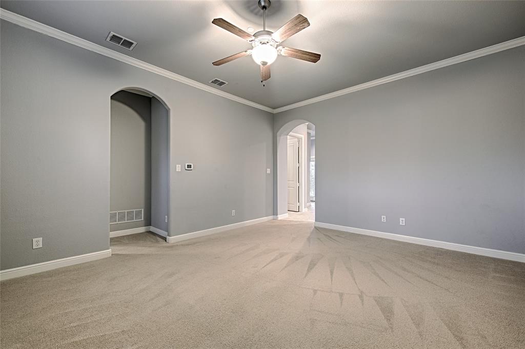 8329 Moore Street Frisco, TX 75034 - Photo 25 of 30 Unfurnished room with crown molding, light carpet, ceiling fan, and arched walkways