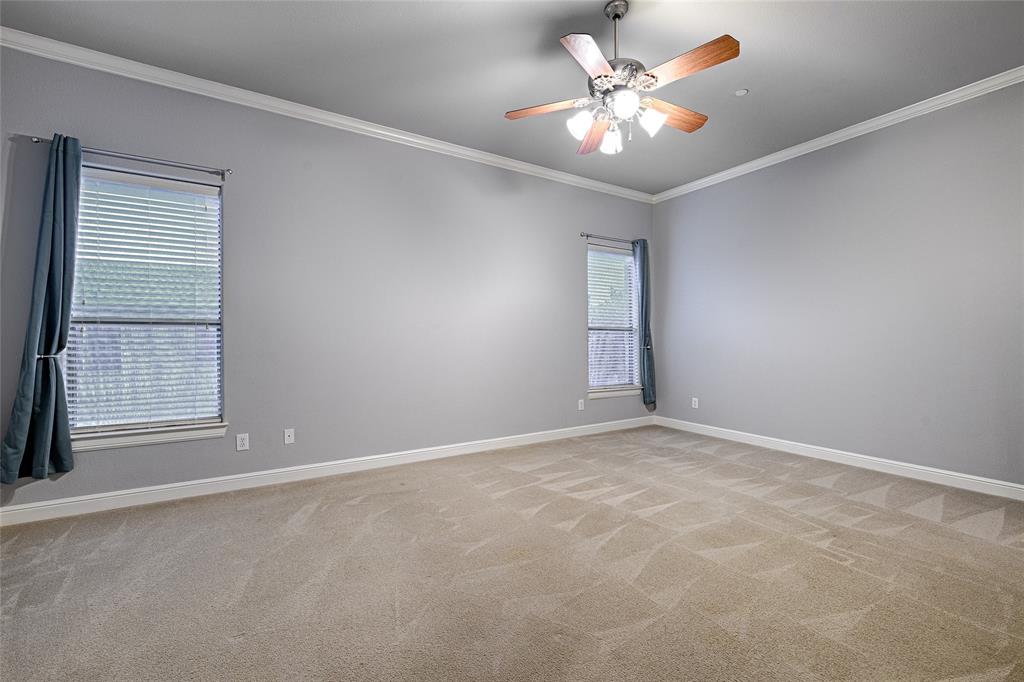 8329 Moore Street Frisco, TX 75034 - Photo 26 of 30 Unfurnished room with ornamental molding, light carpet, and ceiling fan