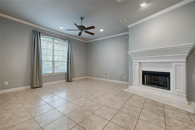a view of an empty room with a fireplace and a window
