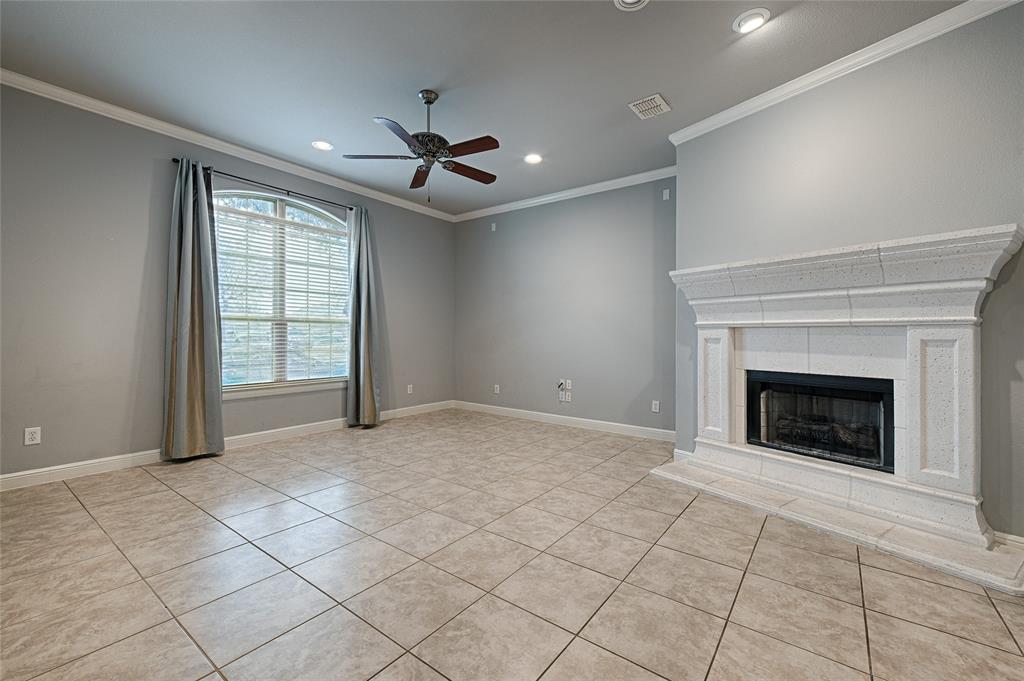 8329 Moore Street Frisco, TX 75034 - Photo 3 of 30 Unfurnished living room featuring light tile patterned floors, recessed lighting, a fireplace, ornamental molding, and a ceiling fan