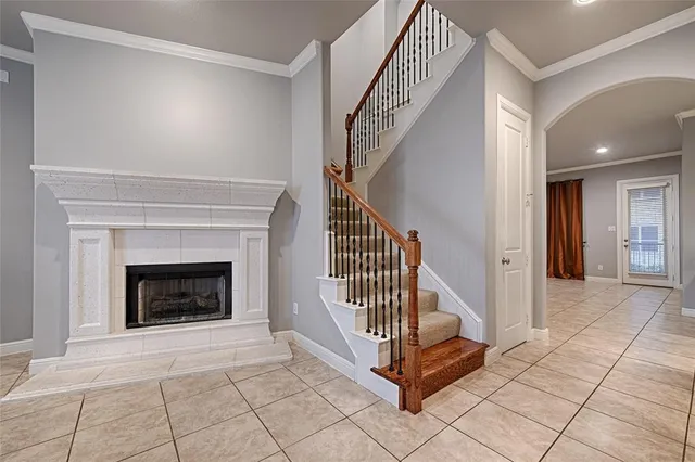 a view of a livingroom with a fireplace and stairs