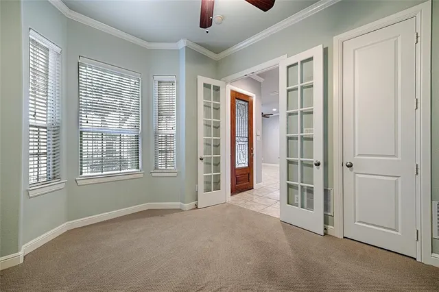 an empty room with windows and entryway
