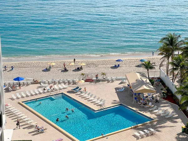 a view of a swimming pool with chairs