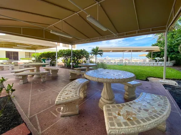 a view of a two chairs in the patio